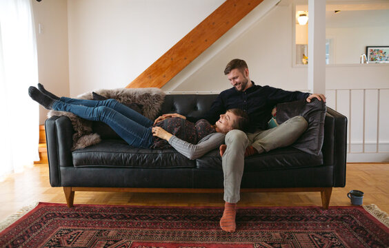 Happy young expecting caucasian couple hanging out at home - cud