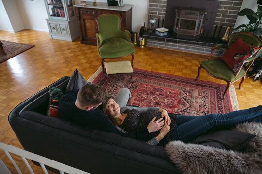 Happy young expecting caucasian couple hanging out at home - cud