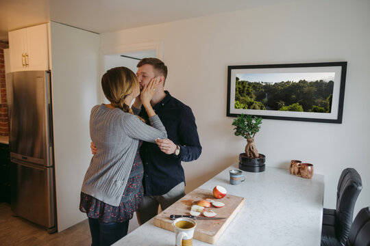 Happy young expecting caucasian couple hanging out at home - kis