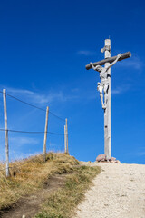 Statue of Jesus on cross at the top of Seceda in Dolomites, South Tyrol, Italy