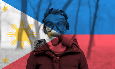 Photo of woman wearing protective gas mask against the background of the Philippines flag. 