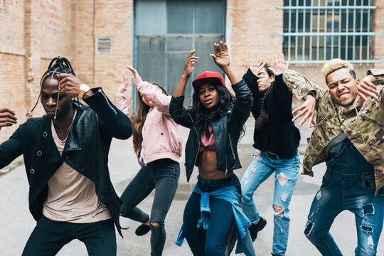 Group of friends dancing hip hop on the street.