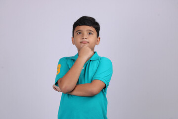Thinking indian child deep in thought concept for confusion, brainstorming, indecision, uncertainty...