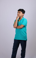 Thinking indian child deep in thought concept for confusion, brainstorming, indecision, uncertainty...