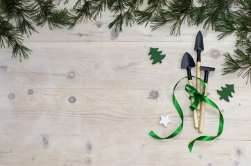 Christmas gardening tools on white wooden table. Top view, flat lay