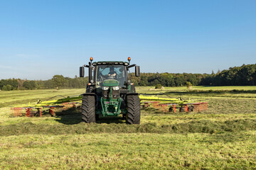 Obraz premium Tractor with tedder in the field - 3824