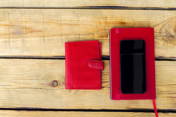 Red Wallet, Red Diary and Smart Phone on wooden background. Top view. Christmas shopping time Christmas online shopping. Black friday Big Sale. Flat lay. Special Christmas offer discount text on phone