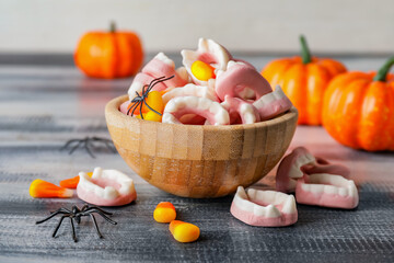 Bowl with tasty treats for Halloween on table
