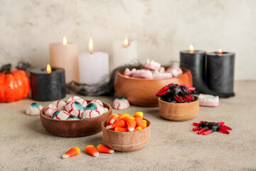 Halloween composition with tasty treats on grey background