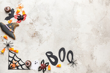 Halloween composition with tasty treats on light background