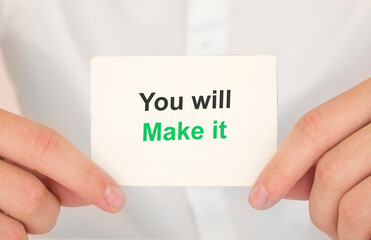 Man's hands take a card with words You will make it, finance and business concept.