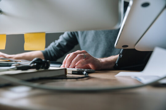 Person sitting at desk with computer.