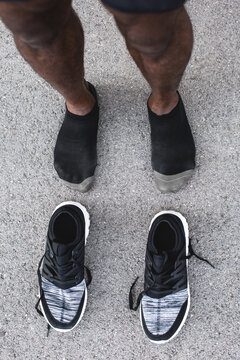 Black sneakers of a young black runner, close-up.