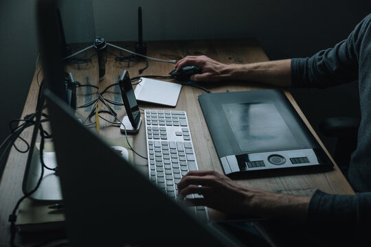 Person sitting at desk with computer.