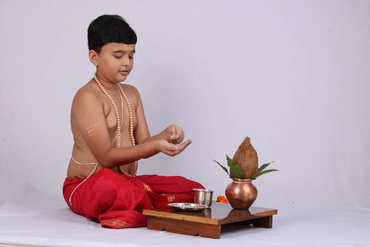 young Indian boy Offering Sandhyavandanm - salutation to Goddess during evening time. a mandatory religious ritual performed by Dvija Hindus.