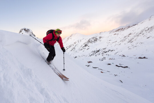 Caucasian woman skiing downhill a steep ski slope