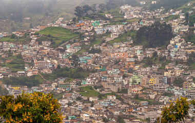Quito, Ecuador - December 2, 2008: Seen from Cerro El Panecillo down. Green hill slopes with...