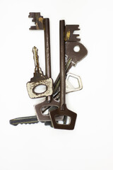 Ancient keys, used for long time. Vintage key on white background. Old key isolated. Keys on table. 