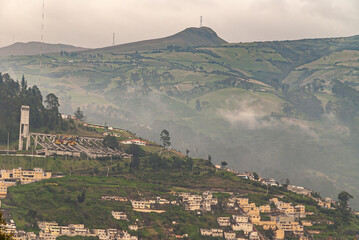 Quito, Ecuador - December 2, 2008: Seen from Cerro El Panecillo down. Yellow housing on green slope...
