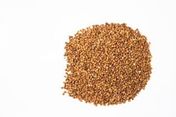Buckwheat on a white background. Choice buckwheat. Groats on a white table.