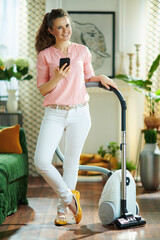 happy modern woman with vacuum cleaner use clean app