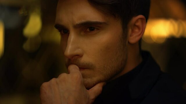 Thoughtful guy face thinking indoors. Young top manager holding hand on chin.