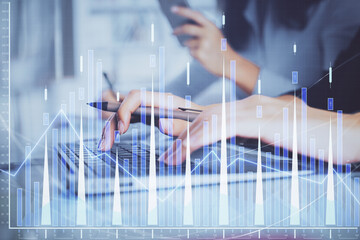 Multi exposure of woman hands typing on computer and financial graph hologram drawing. Stock market analysis concept.