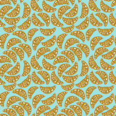 Pattern croissants on blue background 