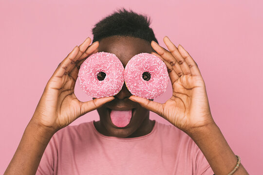 Portrait of a young man with donuts