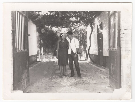 Old scanned photo of a beautiful couple in sixties