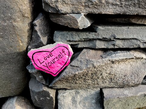love yourself heart-shaped rock