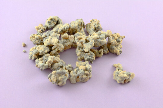 White chocolate cookies and cream candy clusters on lavender background