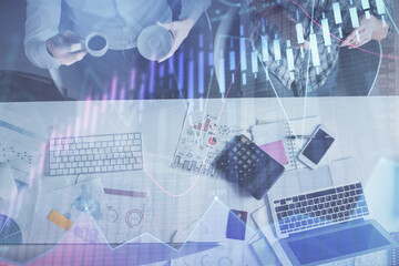 Double exposure of man and woman working together and financial chart hologram drawing. market analysis concept. Computer background. Top View.