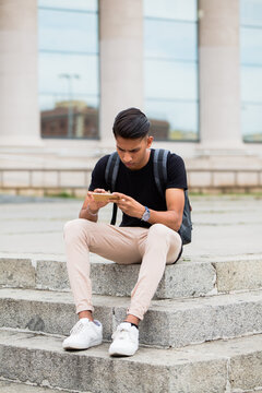 Man using smartphone in a bright location.