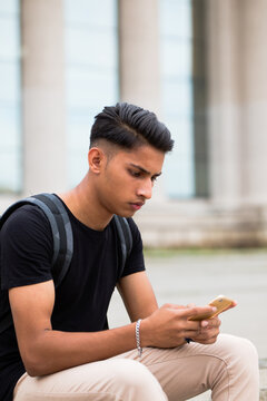 Man using smartphone in a bright location.