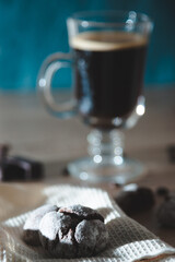 coffee composition with a glass of coffee and sweets on a rustic background close up