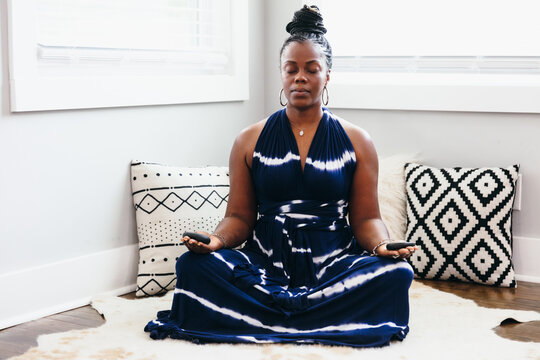Black woman relaxing and meditating at home