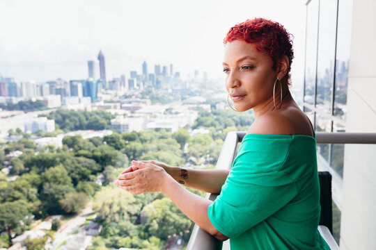 Woman looking out at skyline thinking and reflecting at home
