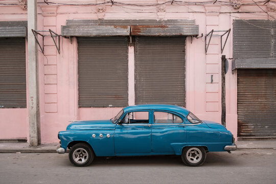 Blue Old-Timer Car In Front Of Pink Facade