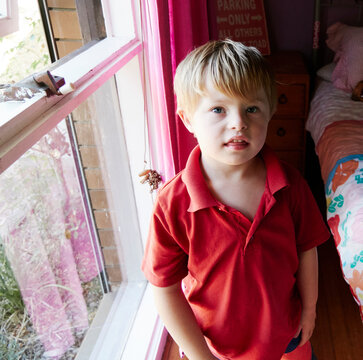 Boy Next to Window in a Room