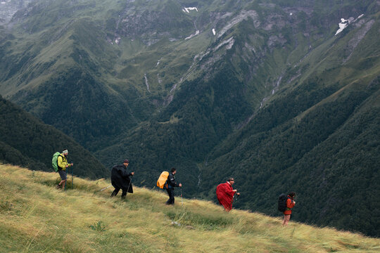 Happy backpackers on a rainy day