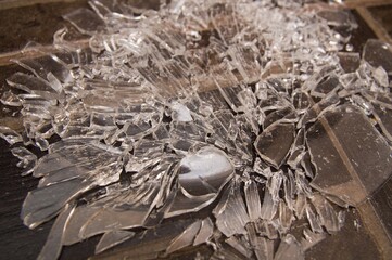 broken glass lies on the brown floor. beautiful pattern