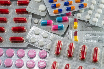 image of multiple medications used by man to benefit his health.