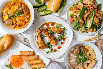Vegan chicken wings made with seitan. Traditional dishes from Vietnam made vegan without real meat using vegetables and meat-substitutes. Meat-free Vietnamese bahn mi, egg rolls, and soup.