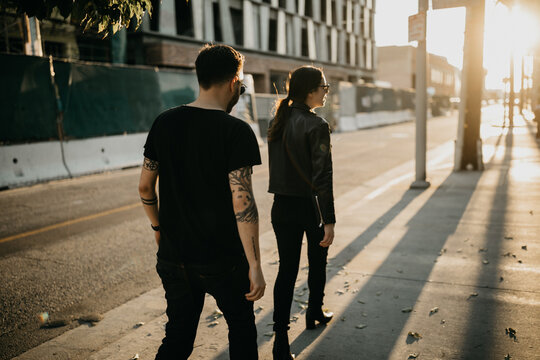 Man and Woman Couple Walking in The Sun Outdoors