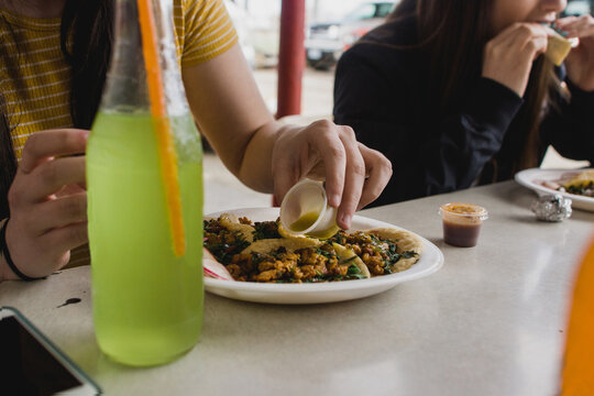 Teenagers Eating Takeout On Road Trip