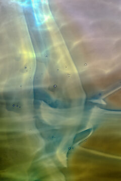 Closeup macrophotograph of patterns and colors inside a handblown glass bowl
