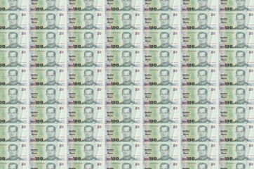 20 Thai Baht bills printed in money production conveyor. Collage of many bills. Concept of currency...