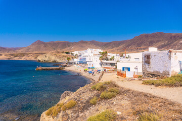Fototapeta premium Beautiful homes along the coast of the Isleta del Moro in the natural park of Cabo de Gata, Nijar, Andalucia. Spain, Mediterranean Sea