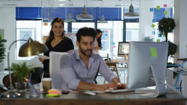 Modern Indian Worker in Office with Colleagues